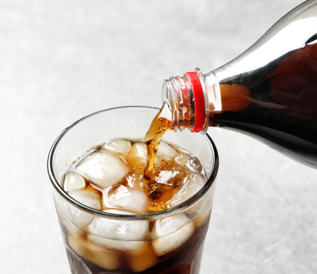 cola being poured from a plastic bottle