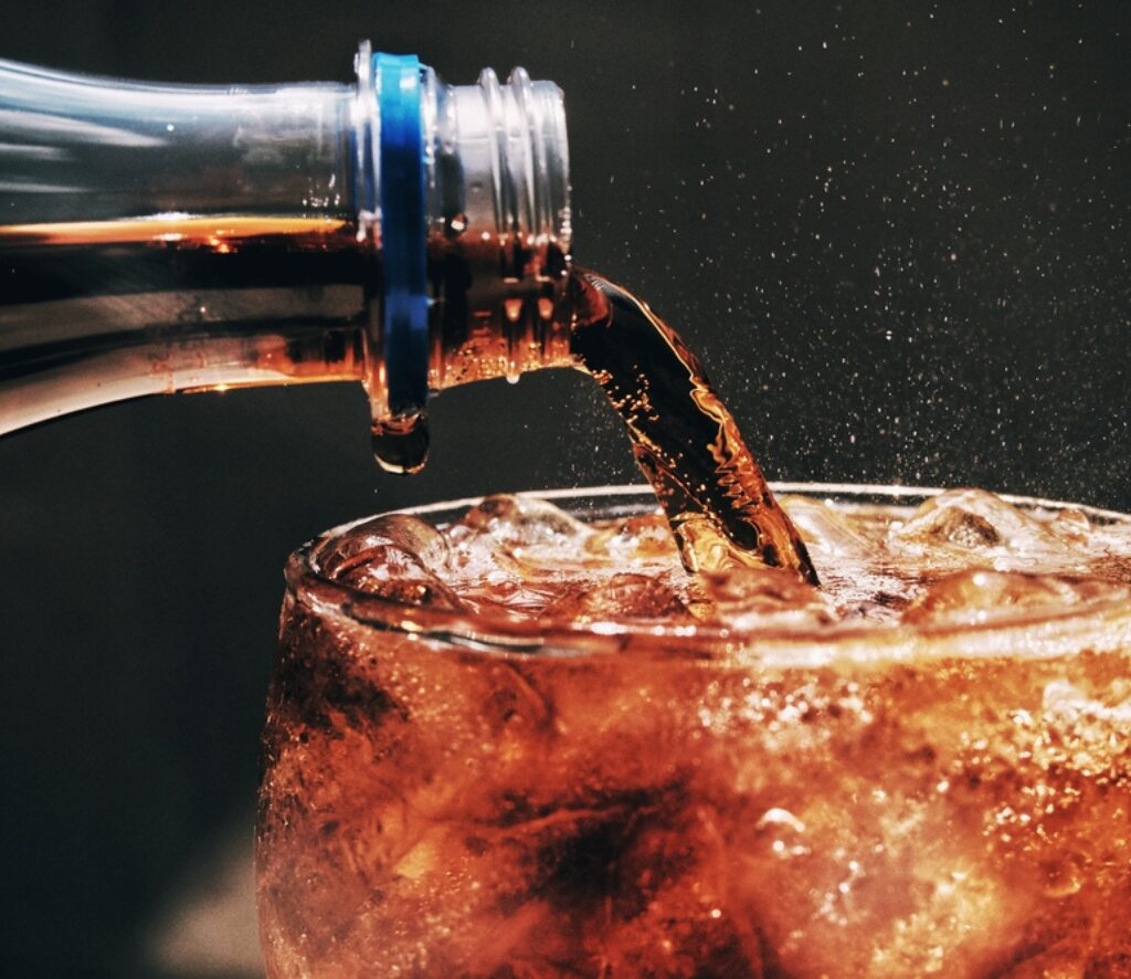 pouring cola into a glass